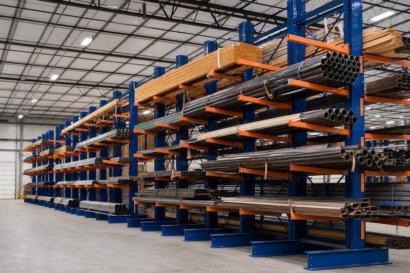 Cantilever rack system storing lumber and steel pipes