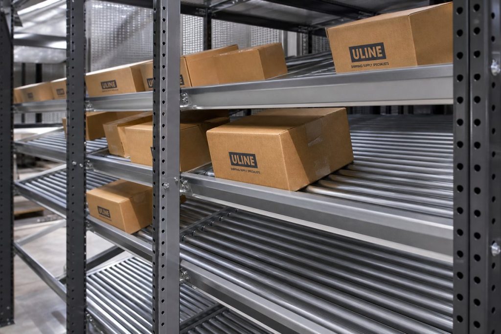 Full-width roller carton flow
