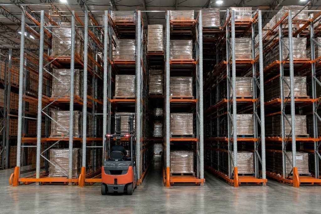 Drive-in pallet rack system with forklift entering deep storage lane — Material Handling USA