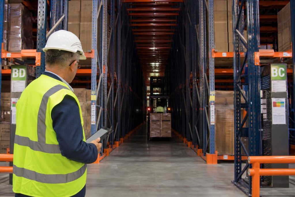 Warehouse manager evaluating drive-in pallet rack lanes