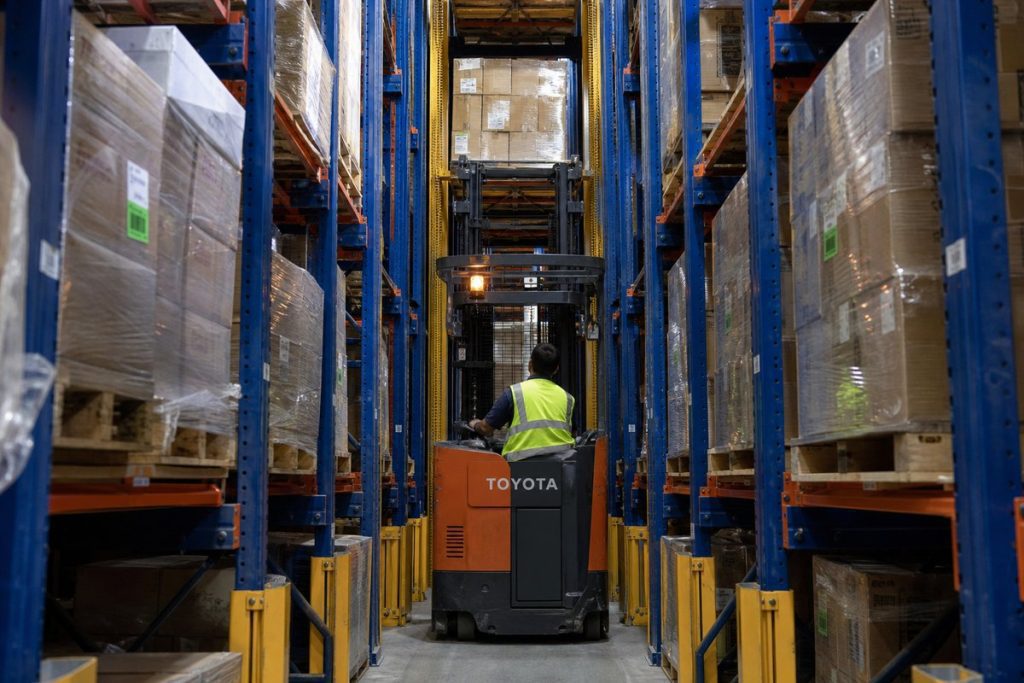 Forklift operating safely in drive-in pallet rack lane