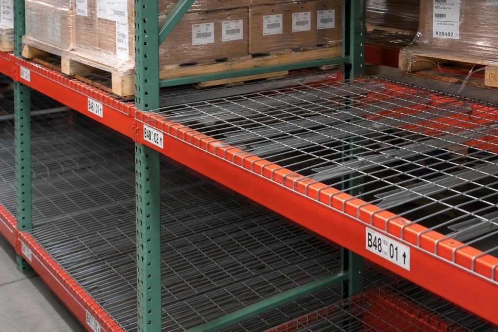 Wire decking panels installed on pallet rack beams