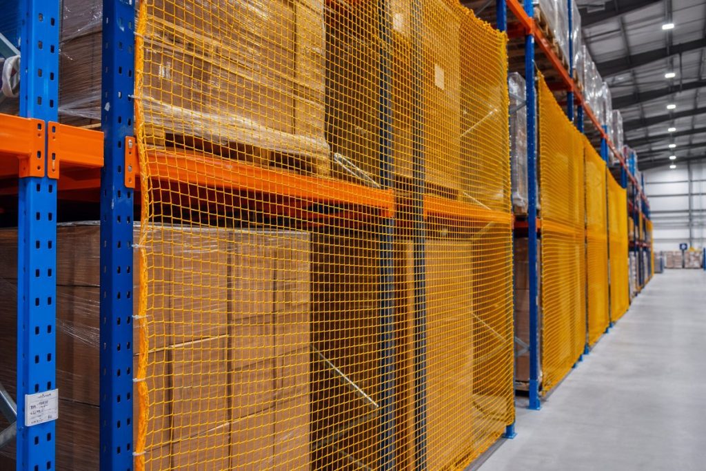 Safety netting installed between pallet rack bays