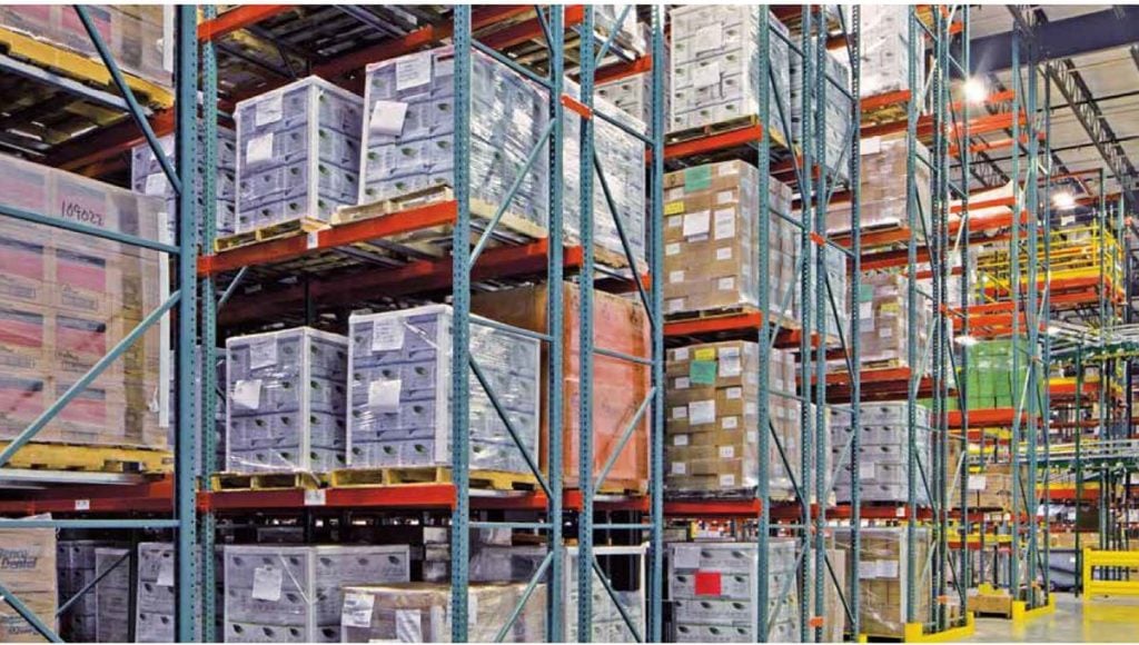Pallet flow rack system with multiple gravity-fed lanes in a distribution center
