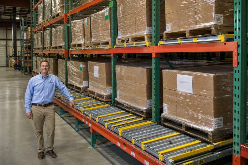 Warehouse manager reviewing pallet flow rack system