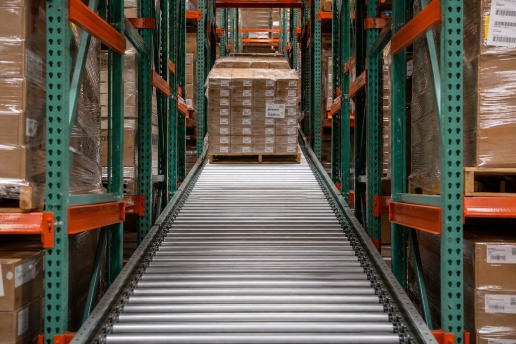 Full-width roller bed pallet flow system
