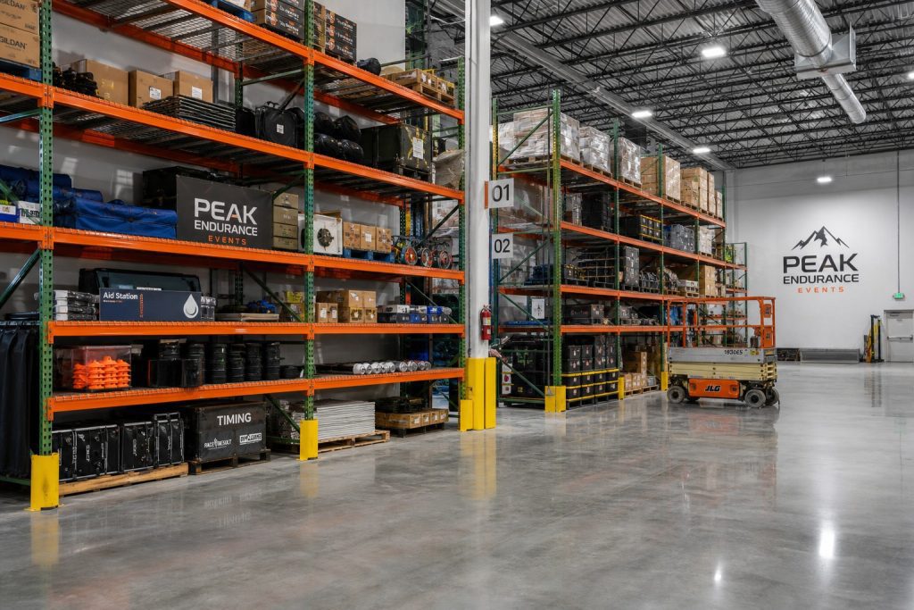 Conceptual illustration of an endurance events warehouse with pallet rack for race supplies and equipment