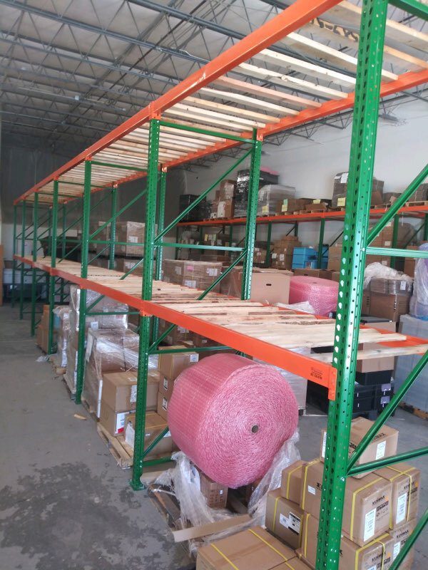 Wide view of pallet rack installation in progress at Sanmina manufacturing facility