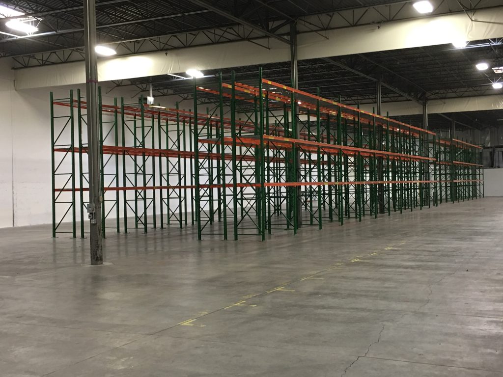 Multiple pallet rack rows with forklift access at Tellworks Communications