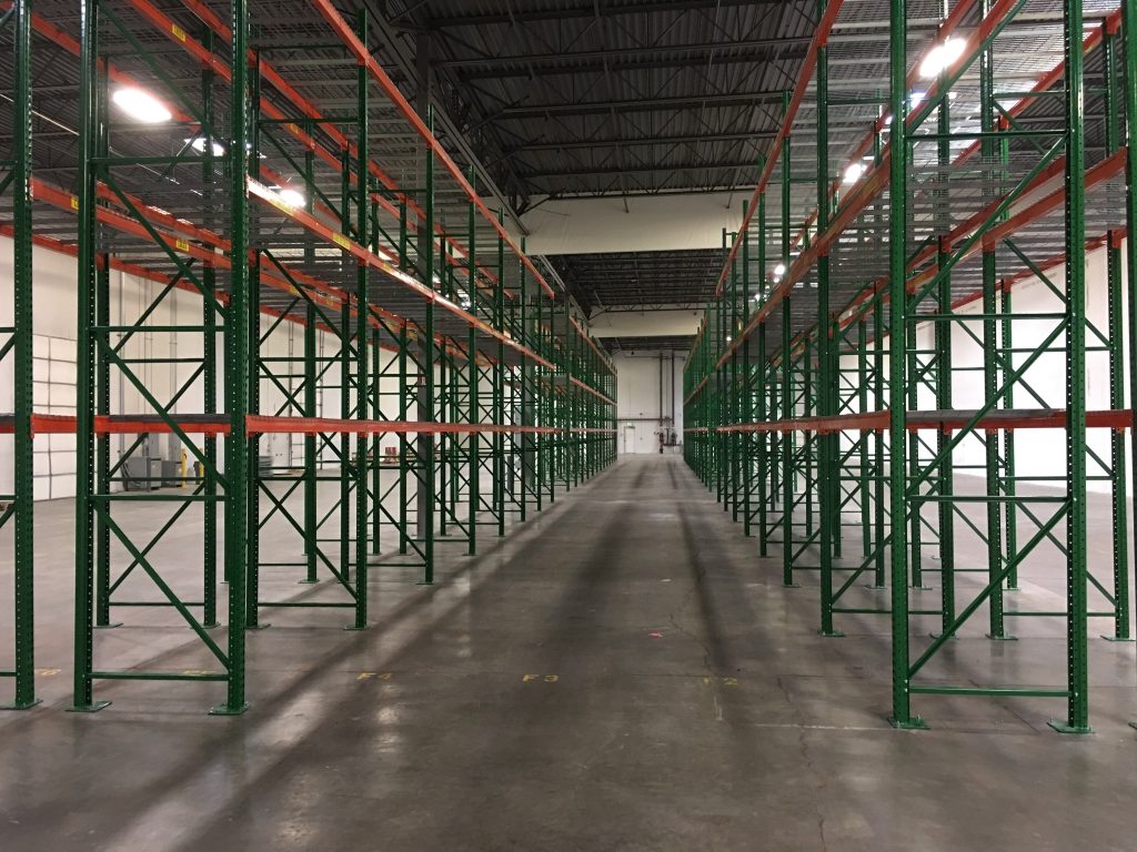 Wide view of pallet rack rows at Tellworks Communications warehouse