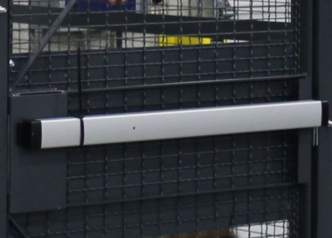Push bar exit hardware on wire mesh driver cage door