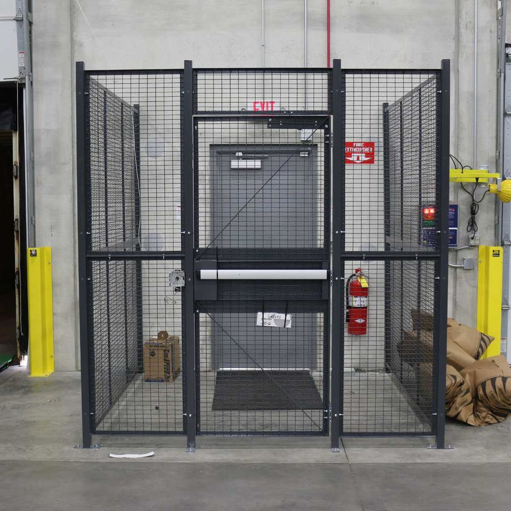 Wire mesh driver access cage installed at dock with push bar exit