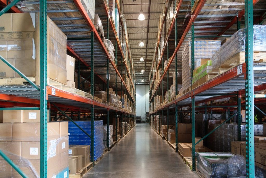 Wire decking panels installed across pallet rack beams in a warehouse bay