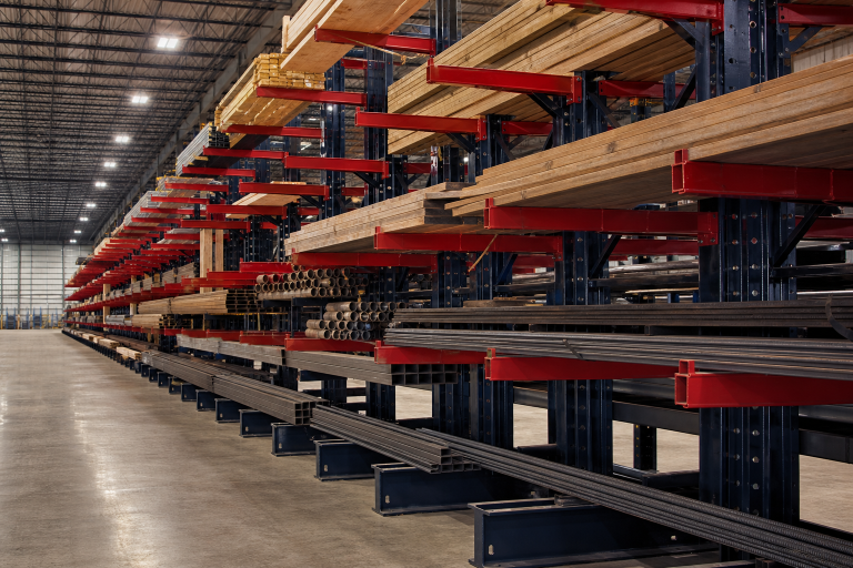 Cantilever rack storage system loaded with lumber and steel in an industrial warehouse