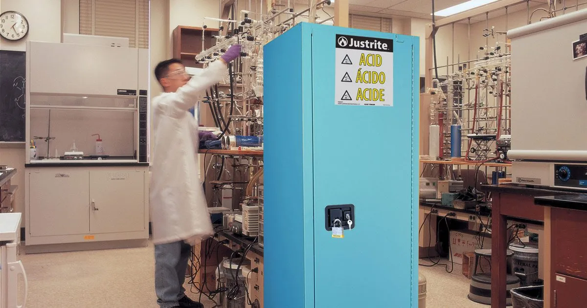 Flammable liquids properly organized inside a yellow Justrite safety storage cabinet