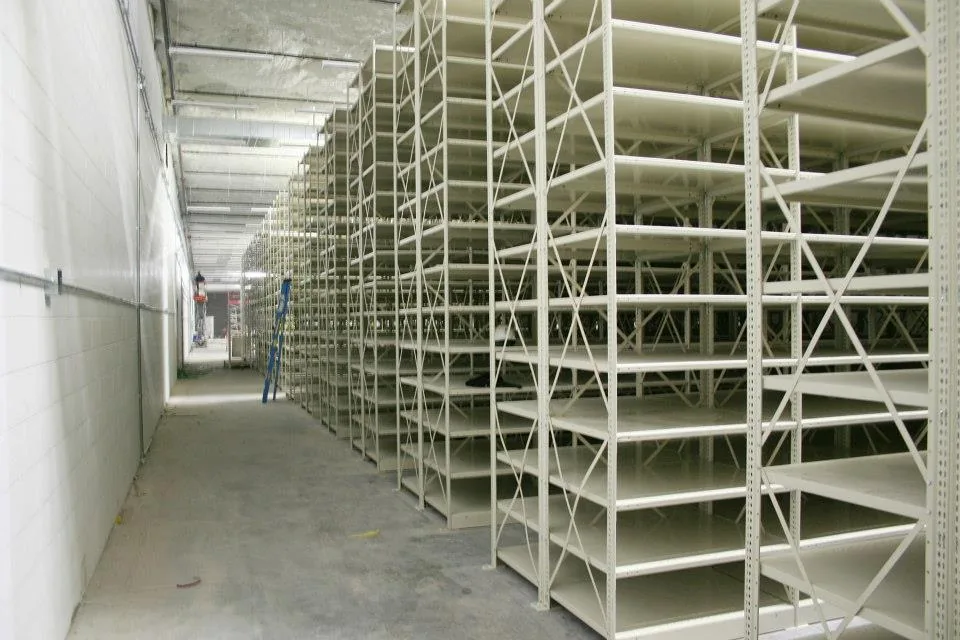 Long run of open-style Penco Clipper shelving with sway bracing in a government supply room