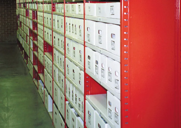 Penco Clipper shelving filled with archive record storage boxes in a records room