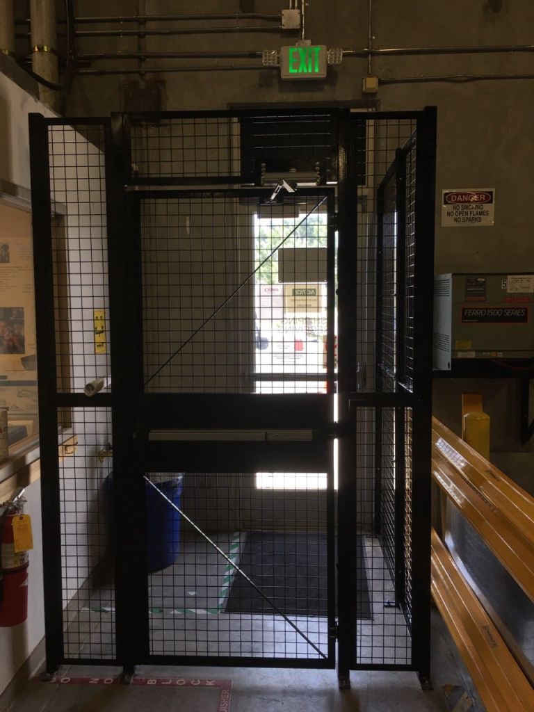 Double door wire mesh security cage opening with push bar exit hardware