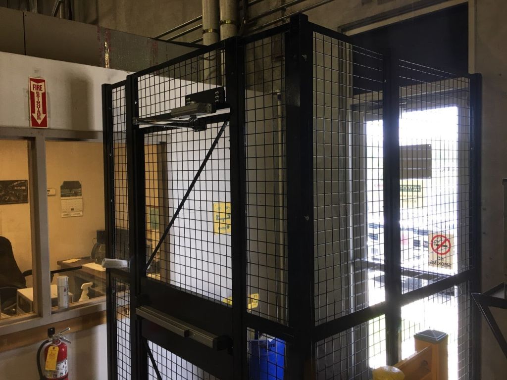 Tool crib and parts cage enclosure with lockable wire mesh door in a plant