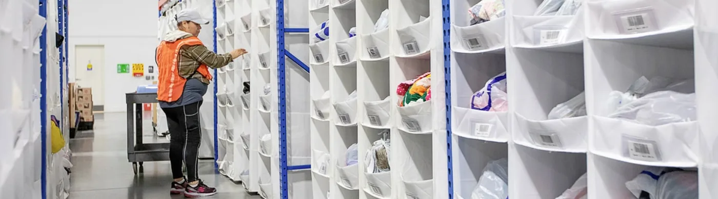 Warehouse aisle lined with UNEX SpeedCell high-density storage cells on both sides