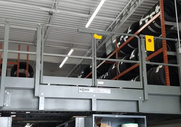 Wildeck rated safety swing gate installed at a mezzanine pallet drop opening
