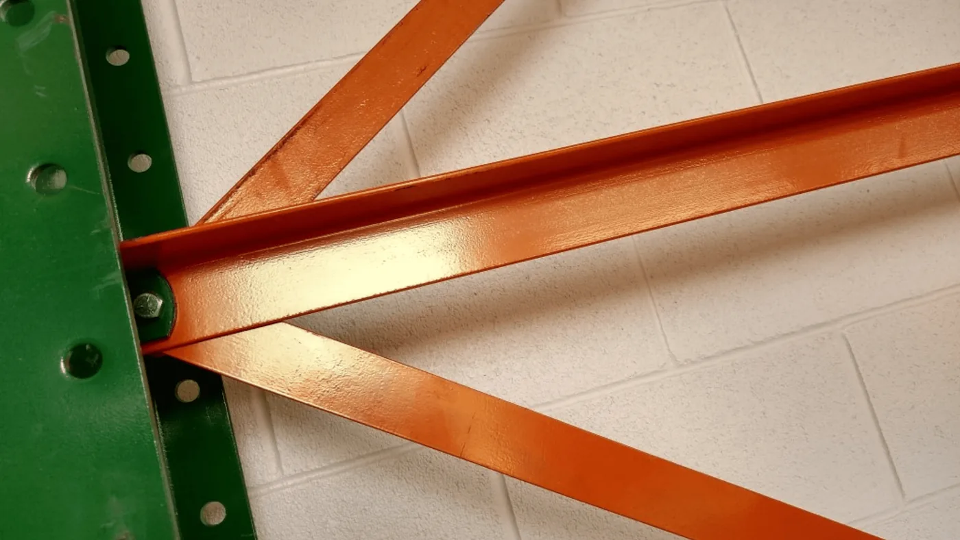 Close-up of the bolted diagonal and horizontal bracing joining two cantilever rack columns