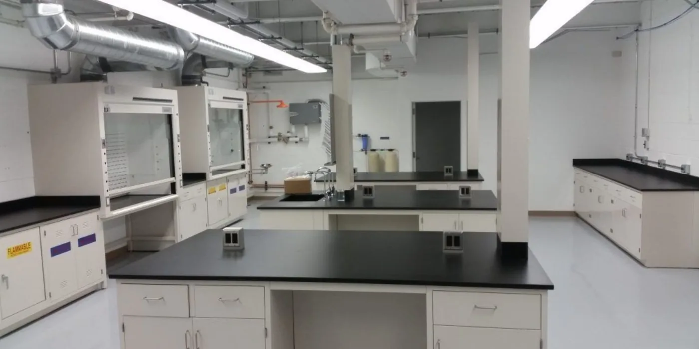 Laboratory casework and fume hoods installed along the wall during a fast-track lab fit-out