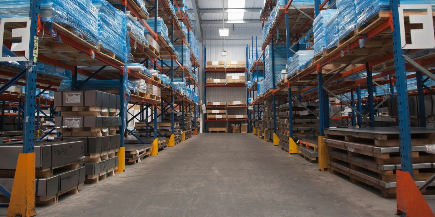 Warehouse worker reviewing a pallet rack for safety risks