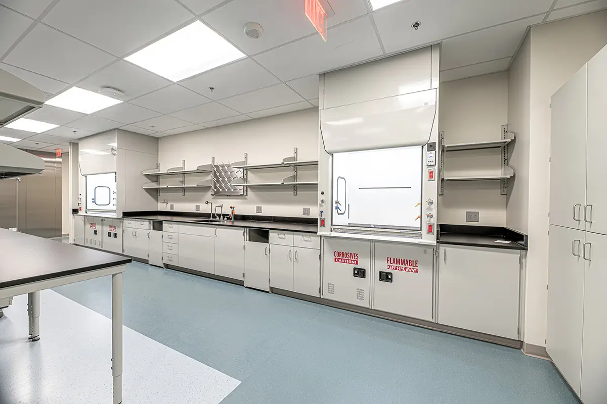 Laboratory casework, fume hood, work surfaces and tall storage for coordinated wastewater treatment plant lab planning