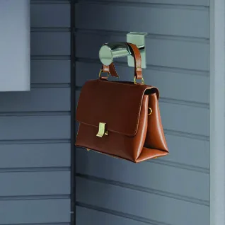Garment and bag hook accessory holding a bag on the slat wall of an Aurora InterActivwall module