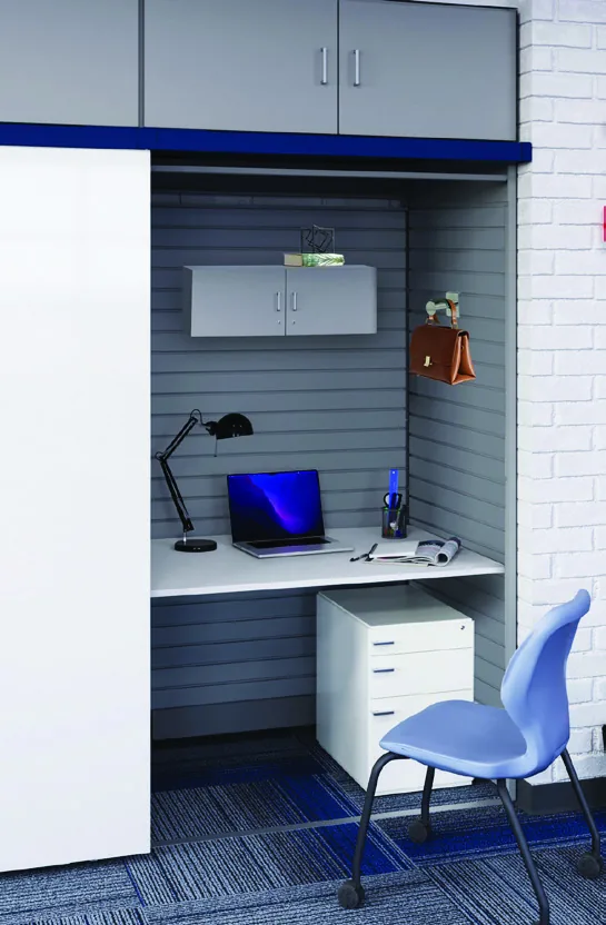 Aurora InterActivwall teacher office module with desk surface, task lighting, laptop and chair behind the sliding whiteboard