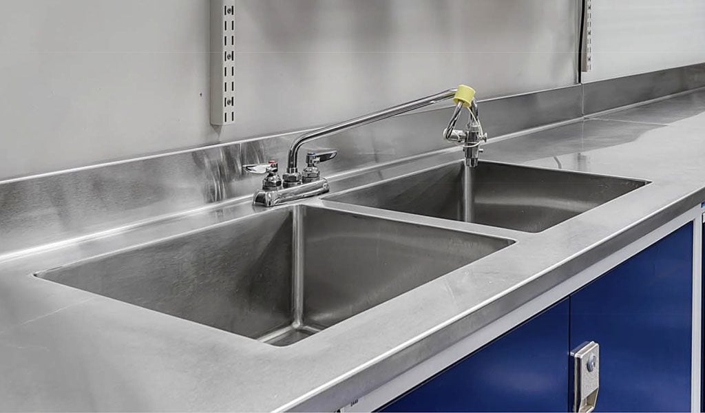 Stainless countertop fabrication with coved sanitary corners for laboratory bench runs
