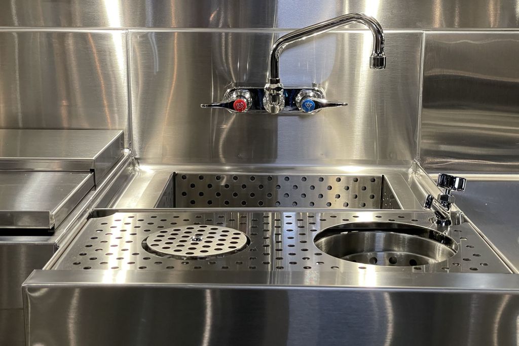 Spec-Bar dump sink with built-in glass rinser and backsplash-mounted faucet