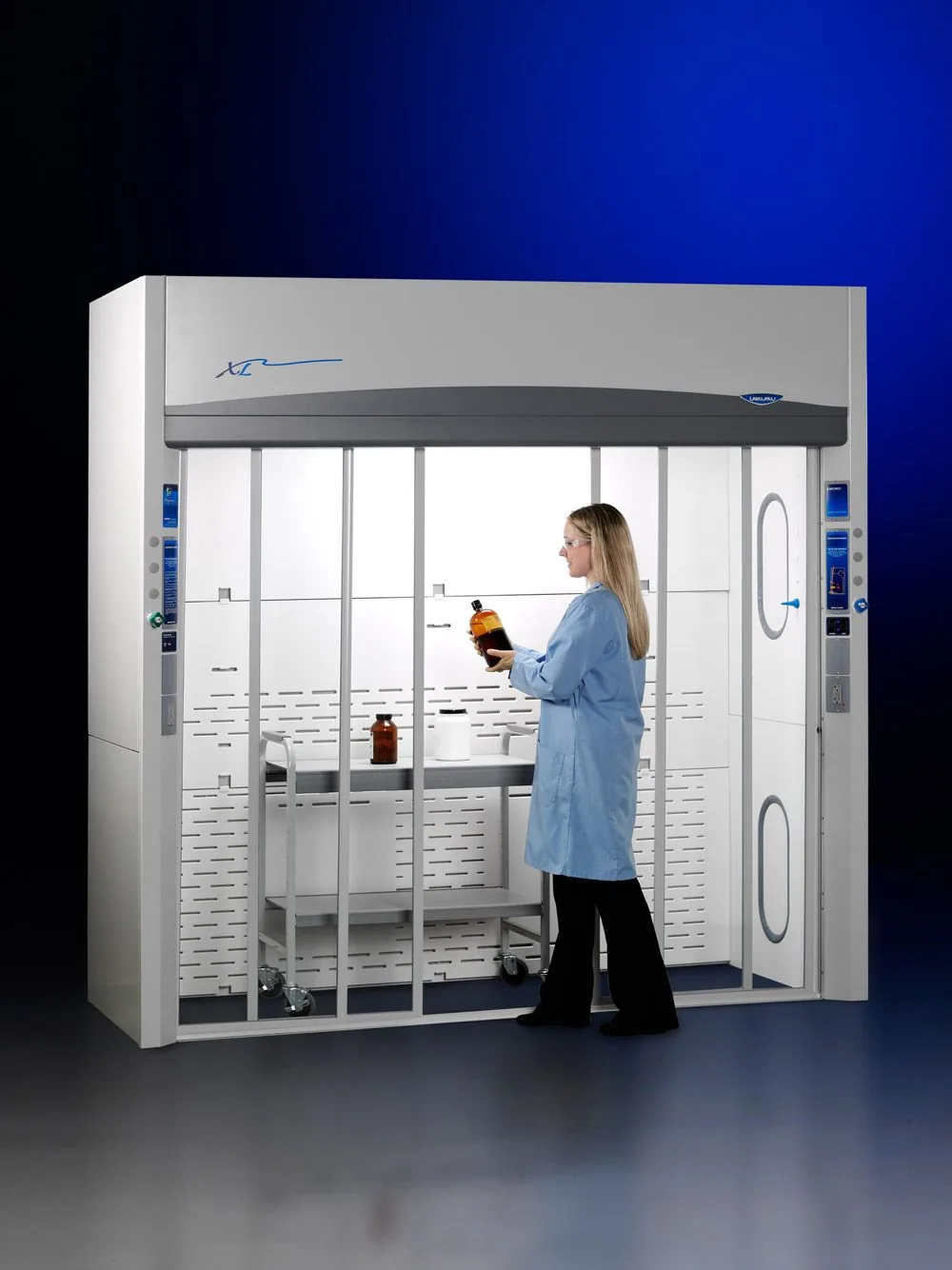 Labconco Protector XL walk-in fume hood with horizontal-sliding sashes and a scientist working inside