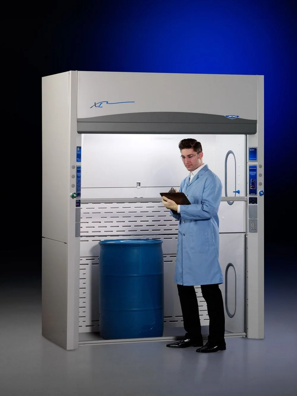 Labconco Protector XL floor-mounted walk-in fume hood with vertical-rising sash and a scientist loading a large drum