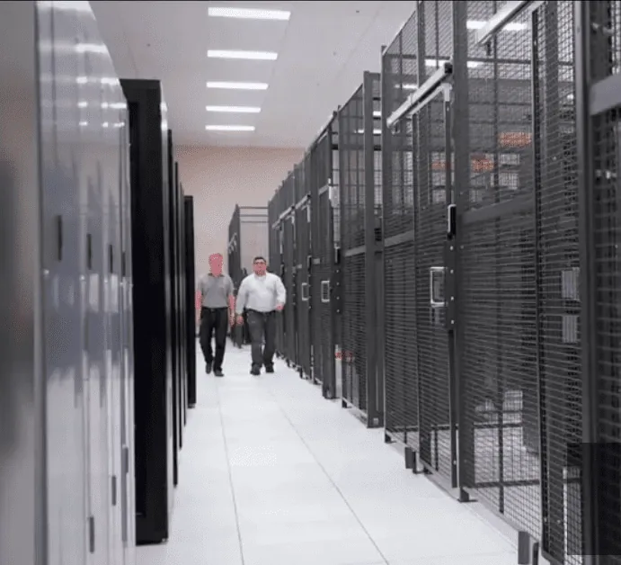 Full-height wire mesh security cage enclosing a data center aisle