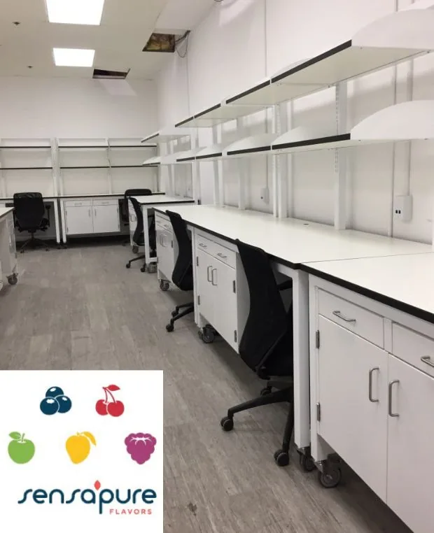 Laboratory casework and mobile work tables with black tops and overhead shelving for Sensapure Flavors