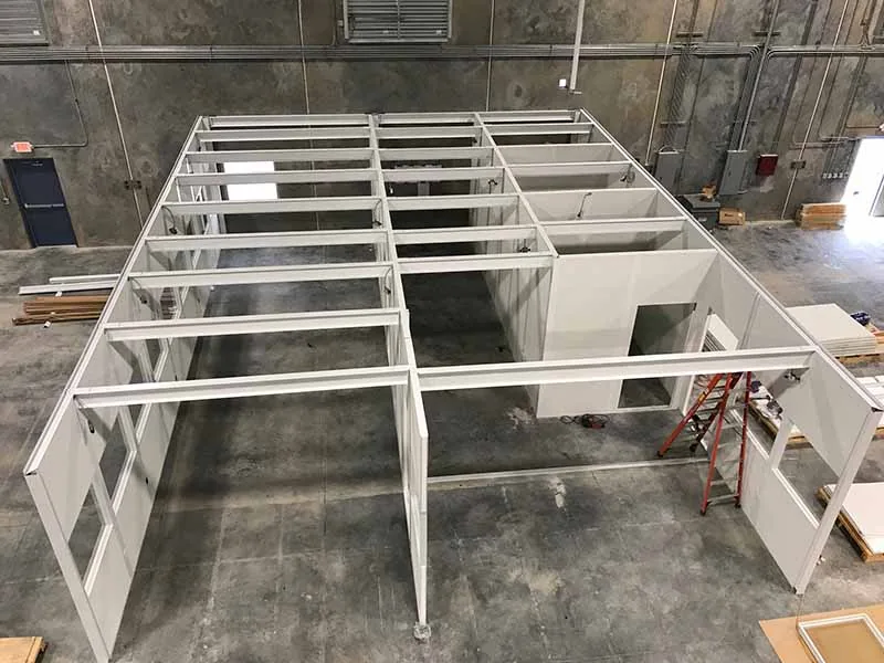 Steel beam framing for a load-rated storage roof over a modular in-plant office