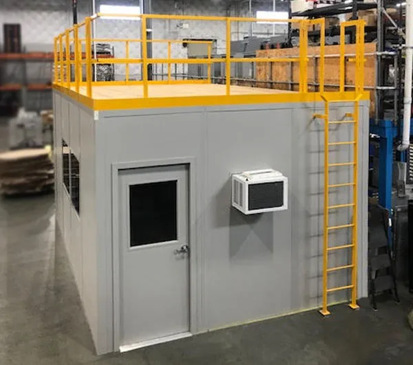 Modular in-plant office with a load-bearing storage roof, yellow guardrail and a fixed access ladder