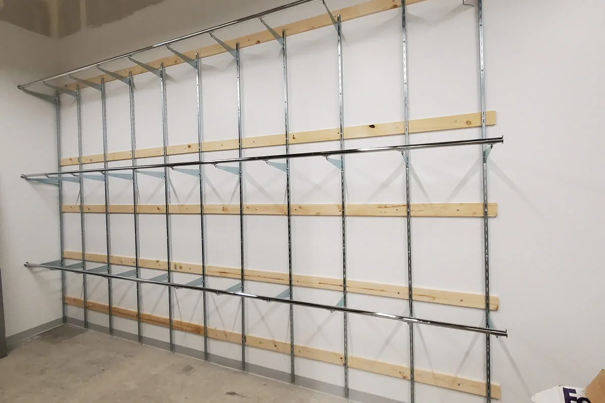 Wall-mounted standards and brackets shelving making use of stockroom wall space