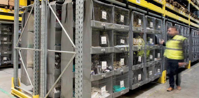 Storeganizer columns installed in existing pallet rack in an operating warehouse