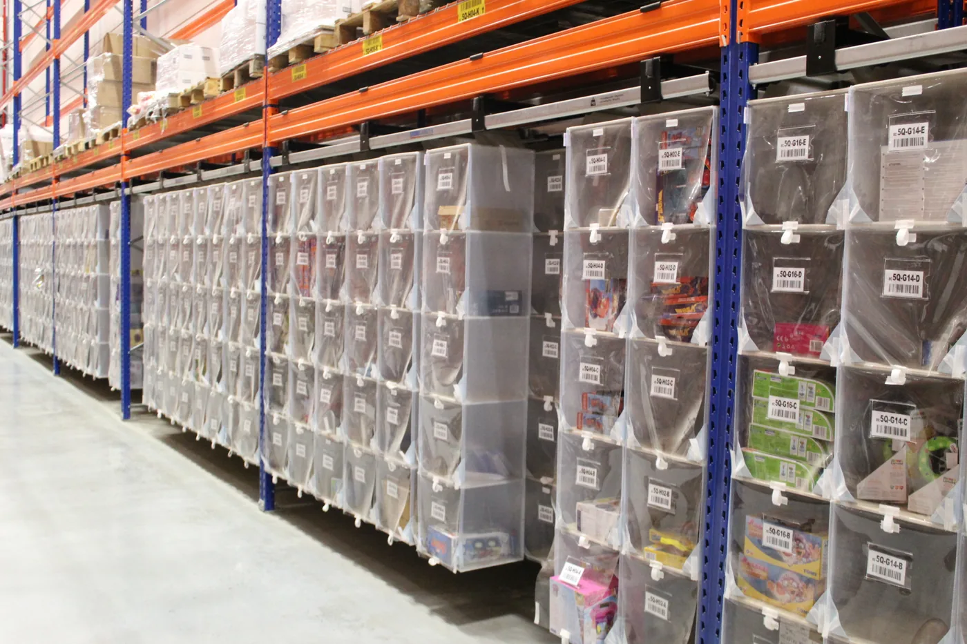 Aisle of Storeganizer textile pocket columns hanging in pallet rack in a distribution centre