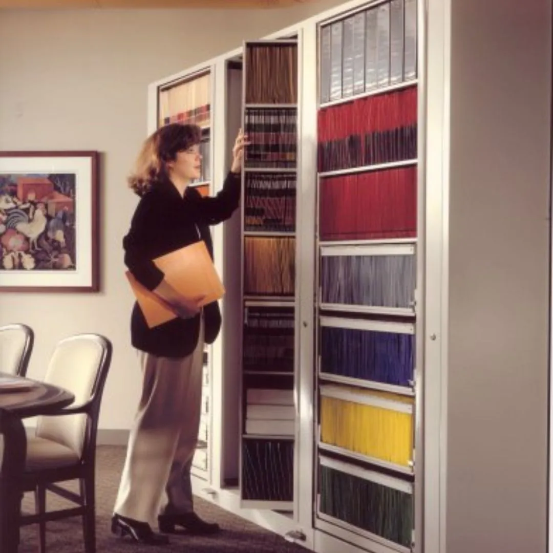 Representative person retrieving a file from a Times-2 rotary cabinet