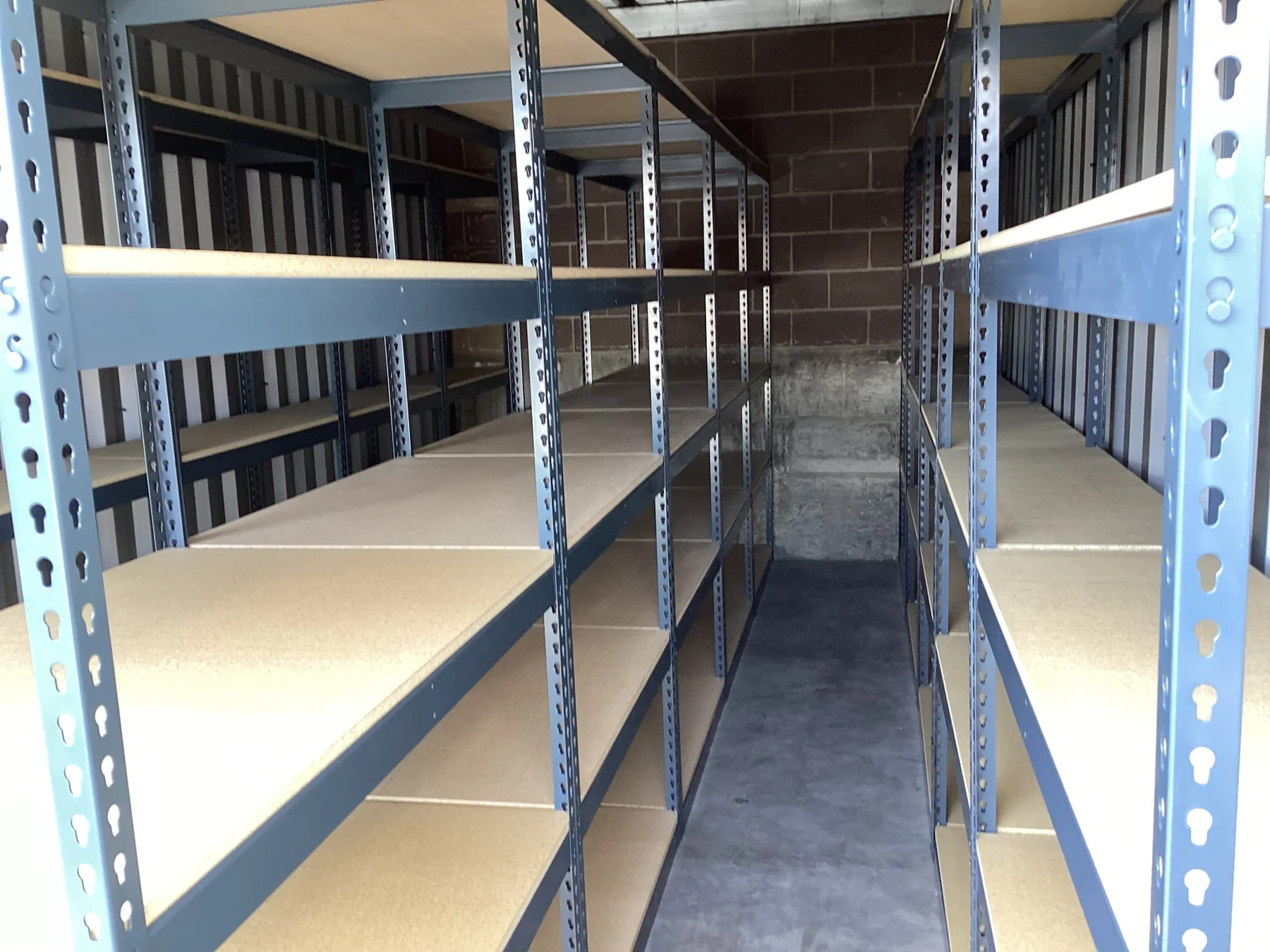 Boltless rivet shelving holding archived legal file boxes in a Lehi, Utah storage unit
