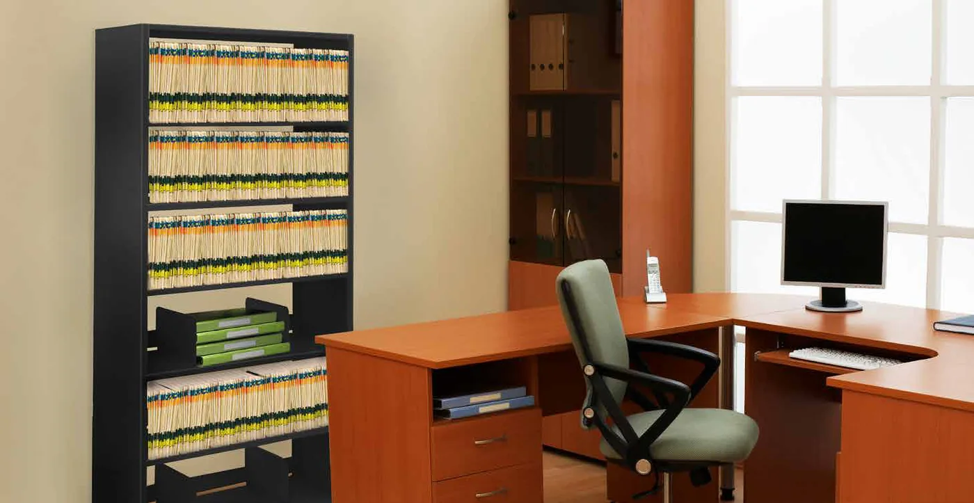 Aurora four-post shelving holding color-coded end-tab files beside a desk in a business office