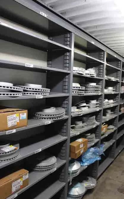 Gray Borroughs Flexi-Bin units with open shelves storing brake rotors and boxed parts