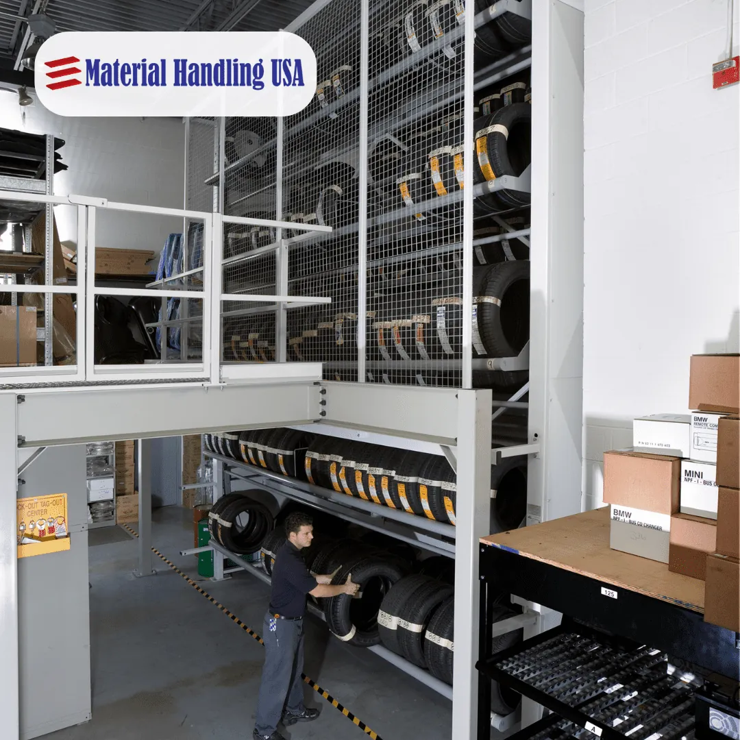 Compact tire carousel installed in a back of shop parts room beside a mezzanine, with a technician loading tires at floor level