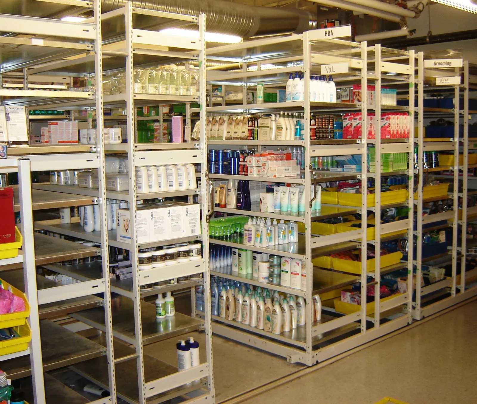 Medical supply shelving with labeled shelf sections and bins that keep each supply category in one place