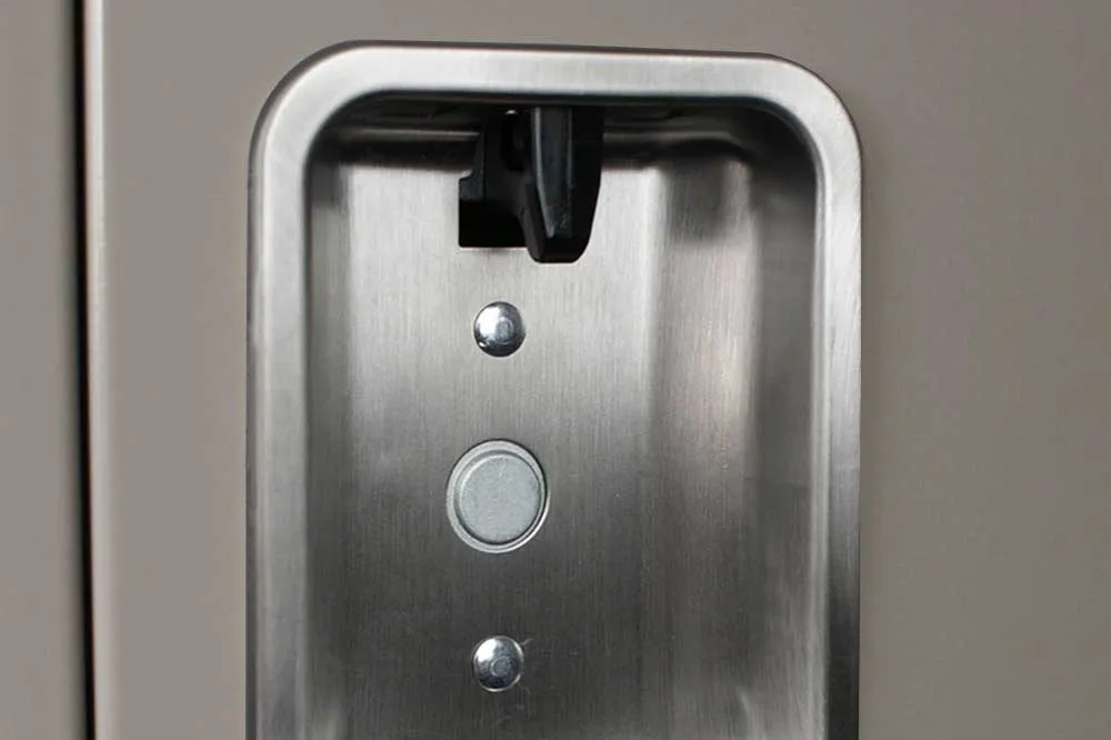 Close-up of a recessed stainless lift handle with padlock hasp on a Lyon steel locker door