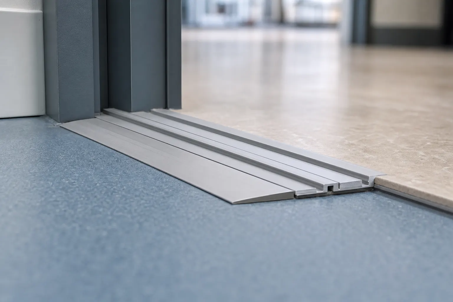 Close up of a low profile floor track with a ramp transition where mobile shelving rails meet the finished floor